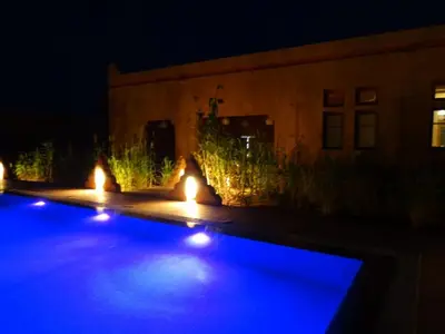a row of lights in a yard at night at Kasbah Tissint in Tissint