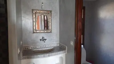 a bathroom with a sink and a mirror on the wall at Kasbah Tissint in Tissint