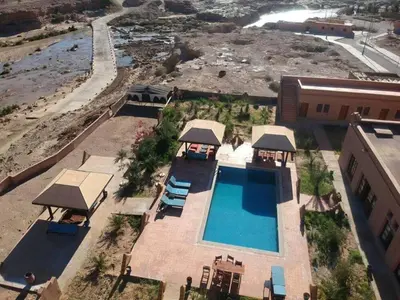 an aerial view of a swimming pool and a building at Kasbah Tissint in Tissint
