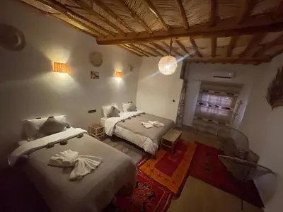 a bedroom with two beds in a room at Hotel Soleil Blue in Boumalne
