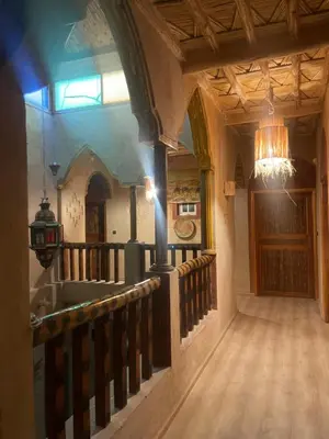 an empty hallway of a building with a chandelier at Hotel Soleil Blue in Boumalne