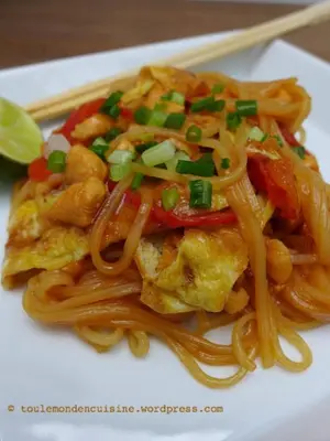 a plate of food with noodles and shrimp with chopsticks at Hotel Soleil Blue in Boumalne