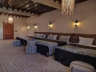 a large room with three beds in it at Camels house apartment in Hassilabied