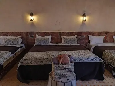 a hotel room with two beds and a basket at Camels house apartment in Hassilabied