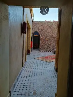 an empty hallway with a tile floor in a building at Camels house apartment in Hassilabied