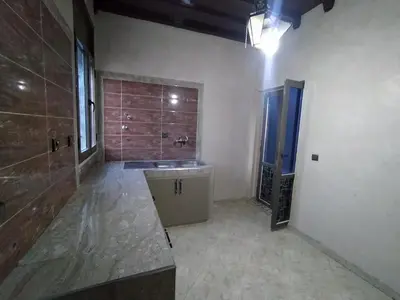 a large bathroom with a sink and a shower at Camels house apartment in Hassilabied