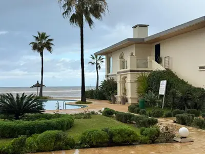 a house with a view of the ocean at Very nice apartment with sea and pool views in Oulad Akkou