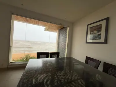 a dining room with a table and a view of the ocean at Very nice apartment with sea and pool views in Oulad Akkou