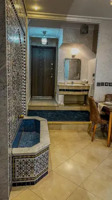 a bathroom with a shower and a sink and a tub at My Amir in Fès