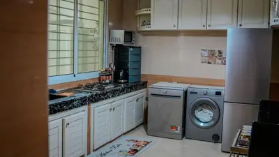 a kitchen with a washing machine and a washer at My Amir in Fès