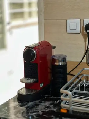 a red coffee maker sitting on top of a counter at My Amir in Fès