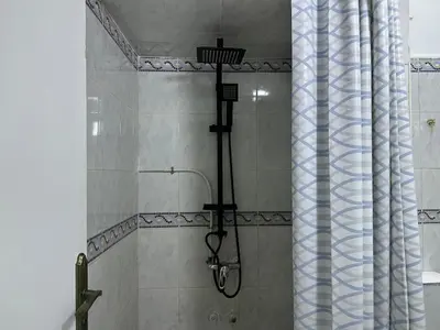 a shower in a bathroom with a shower curtain at Apartment 5 mins from downtown in Fès