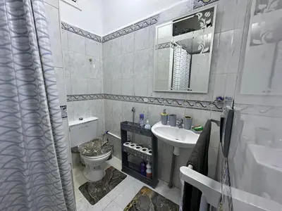 a bathroom with a toilet and a sink at Apartment 5 mins from downtown in Fès
