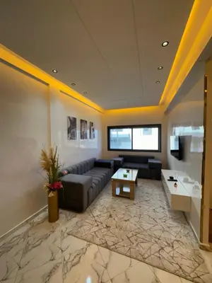 a large living room with a couch and a table at Appartement de standing supérieur à Fès en Route de Meknès in Douar Trhaïtia