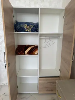 a closet with white cabinets in a room at Appartement de standing supérieur à Fès en Route de Meknès in Douar Trhaïtia