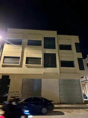 a car parked in front of a building at night at Appartement de standing supérieur à Fès en Route de Meknès in Douar Trhaïtia