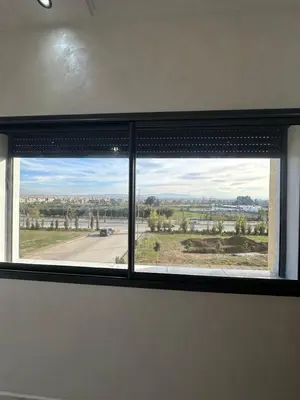 a window in a room with a view of a road at Appartement de standing supérieur à Fès en Route de Meknès in Douar Trhaïtia
