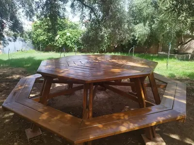 a wooden picnic table sitting in a park at Luxurious mountain villa in El Ksiba