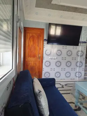 a blue couch in a room with a wooden door at Luxurious mountain villa in El Ksiba