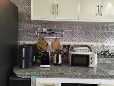 a kitchen counter with a microwave and other appliances at Luxurious mountain villa in El Ksiba