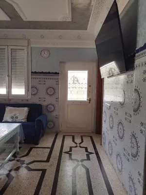 a bedroom with a blue couch and a window at Luxurious mountain villa in El Ksiba