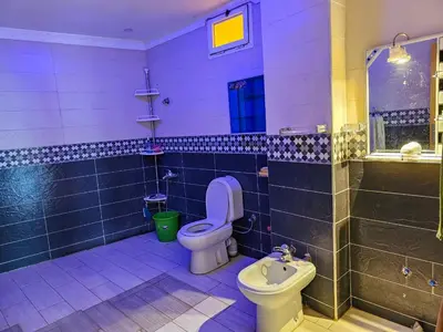 a bathroom with a toilet and a sink at Villa rue imouzzer in Fès