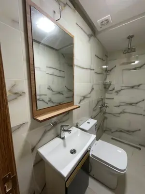 a bathroom with a sink and a toilet and a mirror at Hôtel kairouan in Fès