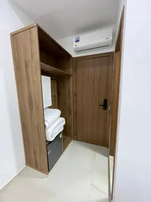 a room with a wooden cabinet with towels in it at Hôtel kairouan in Fès