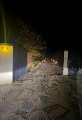 an empty road at night with lights on it at Les Domes de l Ourika in Sidi Bouzguia
