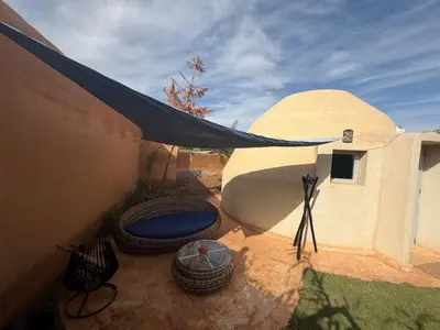 an outdoor patio with a tent and a table at Les Domes de l Ourika in Sidi Bouzguia