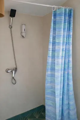 a shower curtain in a room with a microphone at Les Domes de l Ourika in Sidi Bouzguia