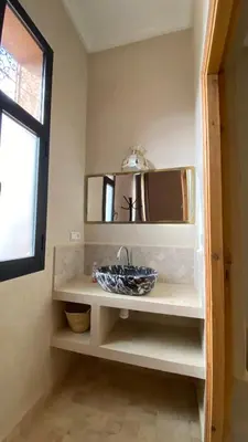 a bathroom with a sink and a mirror at Itrane sahara Auberge in Taouz