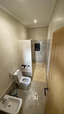 a bathroom with a toilet and a sink at Itrane sahara Auberge in Taouz