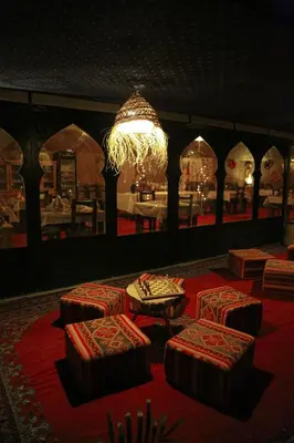 a room with four stools and a chandelier at Star Desert Camp Merzouga in Merzouga