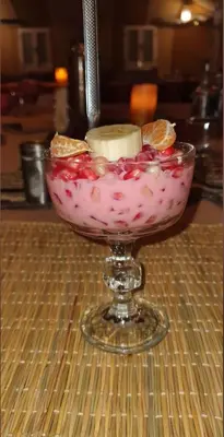 a glass bowl with fruit in it on a table at Star Desert Camp Merzouga in Merzouga
