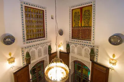a room with a chandelier and plates on the wall at Casa Aya Medina in Fès