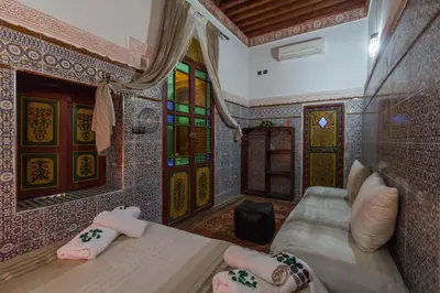 a room with a bed in a room with mosaicked walls at Casa Aya Medina in Fès
