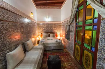 a bedroom with a bed and a couch in a room at Casa Aya Medina in Fès