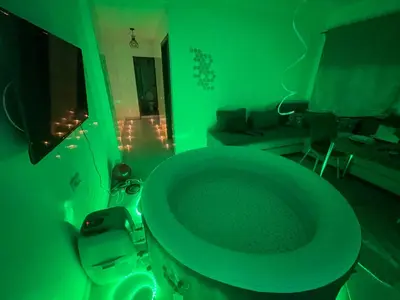 a green bathroom with a toilet in a room at Luxury Jacuzzi Apartment with Romantic Decoration in Fès