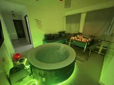 a bath tub in a room with a living room at Luxury Jacuzzi Apartment with Romantic Decoration in Fès