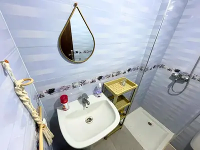 a bathroom with a sink and a mirror at Luxury Jacuzzi Apartment with Romantic Decoration in Fès