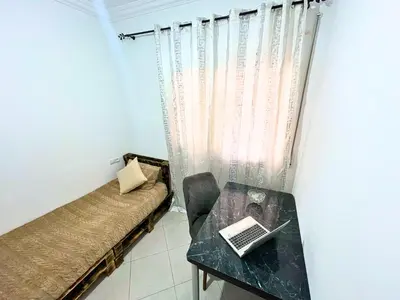 a small room with a table with a laptop on it at Luxury Jacuzzi Apartment with Romantic Decoration in Fès