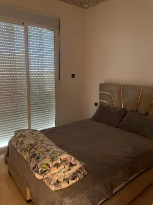 a bedroom with a bed and a large window at Villa Gomez in Sbiti