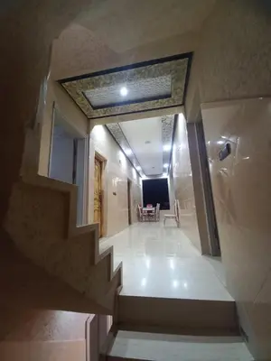 a stairway leading to a room with a table at Villa Gomez in Sbiti