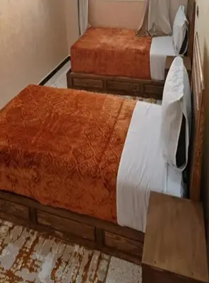 two twin beds in a room with at La Chambre d hote in Ouarzazate