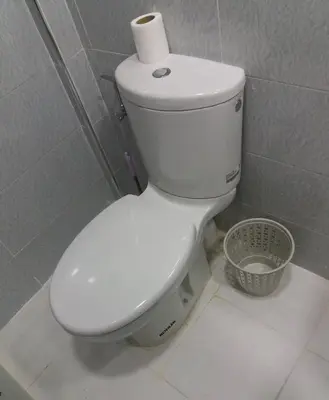a toilet with a roll of toilet paper on top of it at La Chambre d hote in Ouarzazate