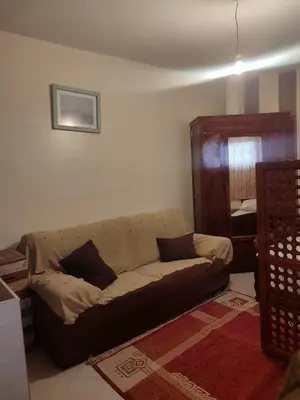 a living room with a couch with pillows on it at Central Bonheur Studio in Midelt