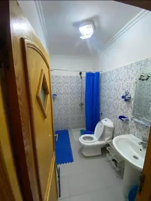 a bathroom with a toilet and a sink at appartement luxe in Meknès