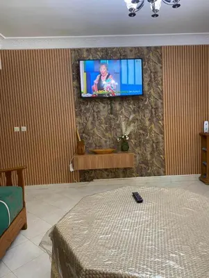 a living room with a flat screen tv on a wall at appartement luxe in Meknès
