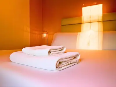 two towels on a bed in a room at Appartement moderne 2 chambres À 5 min de l'aéroport RAK avec Wi-Fi rapide in Oulad Akkou
